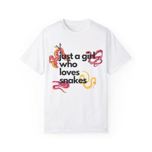 May include: White t-shirt with a graphic of colourful snakes and the text "Just a girl who loves snakes".