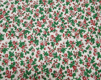 May include: White fabric with a repeating pattern of small red and white flowers with green leaves.