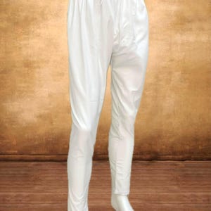 May include: White drawstring pants with a relaxed fit. The pants have a comfortable, loose design and a drawstring waistband. The fabric appears to be lightweight and suitable for warm weather. The pants are displayed on a mannequin.