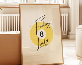 May include: A framed print with a yellow circle and the number 8 inside. The text "Feeling Lucky" is written in black cursive above and below the circle.