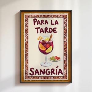 May include: A framed poster with the words "PARA LA TARDE SANGRÍA" in burgundy lettering. The poster features a glass of sangria with fruit and a plate of olives and ham. The frame is black with a decorative border.