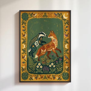May include: A framed rectangular art print featuring a central illustration of a badger and a fox surrounded by a decorative border. The badger has intricate knotwork patterns, while the fox displays floral motifs. The border includes birds, moons, and foliage on a mustard yellow background.