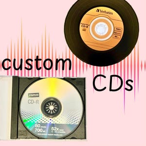 May include: Two blank compact discs, one in a black jewel case and one in a black plastic case. The disc in the jewel case is a Staples CD-R with the text "80 minutes 700 MB 52x speed 1x-52x compatible www.product-support-staples.com". The other disc is a Verbatim CD-R with the text "Digital Vinyl CD-R 700 52x 80".