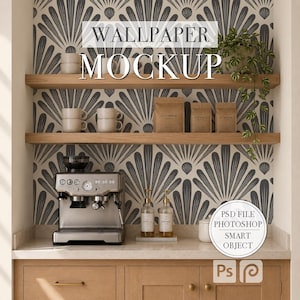 May include: A digital mockup template featuring a kitchen scene with light wood cabinets, two floating shelves, and a gray and white fan-patterned wallpaper. The scene includes a silver espresso machine, ceramic mugs, coffee bags, and a trailing plant.