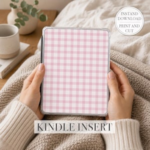 May include: A Kindle insert with a pink and white gingham pattern. The text "KINDLE INSERT" is at the bottom. A circular graphic in the upper right corner reads "INSTAND DOWNLOAD PRINT AND CUT".