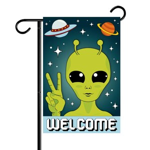 May include: A green alien with large eyes and a peace sign is waving. The alien is on a blue background with stars and planets. The text "WELCOME" is written in white pixelated letters at the bottom of the image.