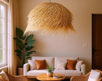 May include: A living room scene featuring a large, natural fiber pendant light fixture. The room includes a white sofa with orange pillows, two wicker armchairs, and a round wooden coffee table. A large potted plant is visible.