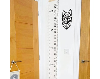 May include: White wooden growth chart with black numbers and a geometric wolf design. The chart measures from 50 to 190 centimeters.