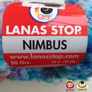 May include: A skein of blue, purple, and white yarn with a label that reads "LANAS STOP NIMBUS" and "www.lanasstop.com". The label also states "50 Grs." and "24 m./27 yds."