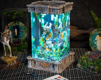May include: A decorative lamp shaped like a stone castle with a glass cylinder containing a blue and green figurine of a wolf and a character from the Legend of Zelda video game series. The lamp has a remote control for changing the color of the light.