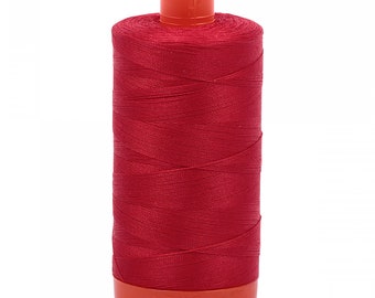May include: A spool of red thread with an orange plastic bobbin.