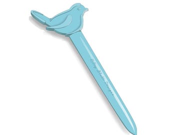 May include: A light blue bird-shaped pen with the text "Riley Blake Designs" printed on the pen's shaft. The pen has a bird-shaped top and a long, slender body.