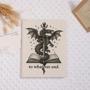 May include: A rectangular notebook with a cream-colored cover featuring a black ink illustration of a dragon coiled around a sword that is piercing an open book. The text "to whatever end." is printed in black below the illustration.