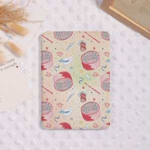 May include: A beige tablet case with a repeating pattern of birthday cakes, owls, wands, and lightning bolts. The cakes have the text "HAPPEE BIRTHDAE HARRY" on them. Other decorative elements include stars and swirls.