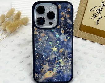 May include: A black phone case with a starry night design. The case features a dark blue background with gold and yellow stars, and a hand-drawn illustration. The case has a black border and a camera cutout.