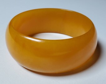 Authentic bakelite bangle, peach color with  swirls  size 6 to a 6.5