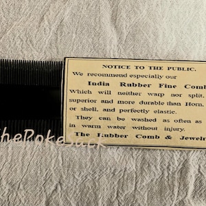 May include: A black rubber comb with a notice to the public about the comb's durability and how to wash it. The notice reads: "NOTICE TO THE PUBLIC. We recommend especially our India Rubber Fine Combs Which will neither warp nor split. much superior and more durable than Horn. Ivory or shell. and perfectly elastic. They can be washed as often as desired in warm water without injury. The Rubber Comb & Jewelry Co."