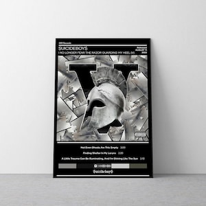 May include: A black and white album cover for the album "I No Longer Fear The Razor Guarding My Heel (V)" by the musical group Suicideboys. The cover features a large, stylized letter "V" made up of multiple images of guns. A silver helmet with a plume is centered in the "V". The album title and artist name are printed in white text on a black background. The album cover also includes a Parental Advisory label.