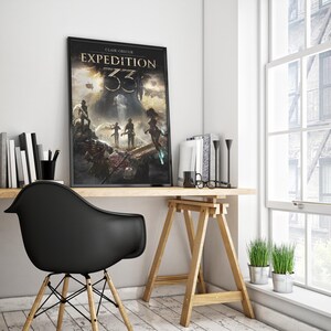 May include: A framed poster with the text "CLAIR OBSCUR EXPEDITION 33" is displayed on a wooden desk. The artwork features a fantasy scene with figures and a dark, dramatic sky. A black chair and a window with a view of a building are also visible.