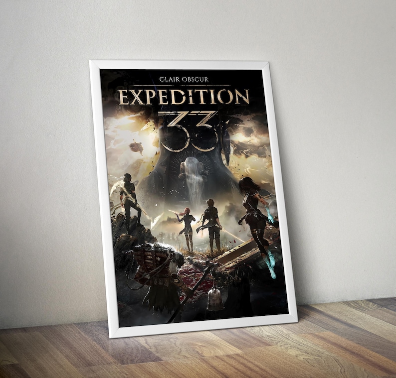 May include: A framed poster with the title "CLAIR OBSCUR EXPEDITION 33". The artwork shows a fantasy scene with figures in a dramatic landscape, and a large, ominous structure in the background. The poster is in a white frame, leaning against a wall.