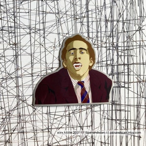 May include: A sticker featuring a cartoon illustration of Nicolas Cage with fangs, wearing a burgundy suit and a blue and white striped tie. The background is a white grid.