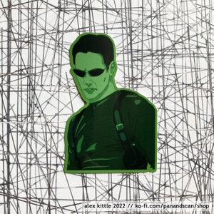 May include: Green and black illustration of a character wearing sunglasses and a black shirt with a holster. The character is looking to the left. The background is a white grid.