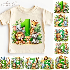 以下が含まれることがあります： クリーム色の幼児用Tシャツ。ジャングルをテーマにしたデザインで、緑色の数字「1」の周りに、ライオン、キリン、シマウマ、ゾウなどの漫画の動物が描かれています。シャツの上部には「Art to Cart CREATIONS」の文字があります。