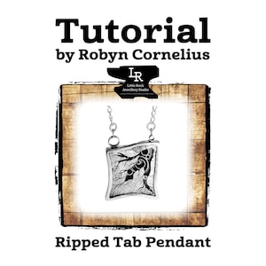 May include: A silver pendant with a ripped tab design, featuring a tree branch with leaves. The pendant is on a silver chain and is labeled "Little Rock Jewellery Studio".