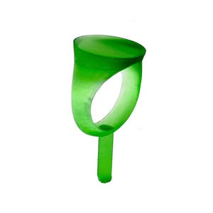 May include: A translucent green ring with a rounded top and a slender band. The ring has a smooth, polished appearance and a small, vertical stem extending from the bottom. The design is simple and modern, with a focus on the vibrant color and form.