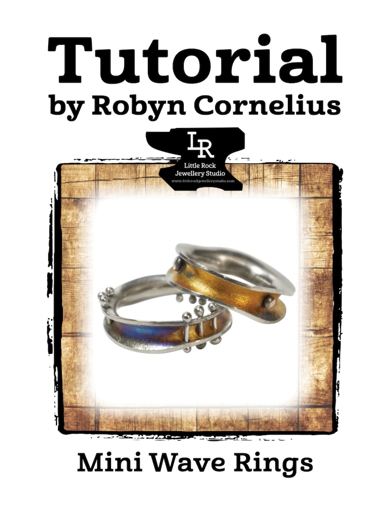 May include: Two silver wave rings with gold and blue enamel. The rings are stacked on top of each other. The image is framed with a woodgrain background. The text "Little Rock Jewellery Studio" is visible in the top right corner of the image.