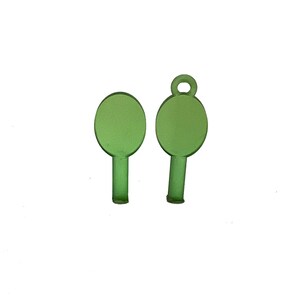 May include: Two translucent green oval-shaped charms. One charm has a small loop at the top, while the other does not. Both charms have a stem-like base. The charms are set against a white background.