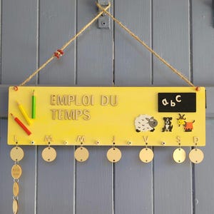 Wooden timetable for children. Can be personalized with the child&#39;s name. Useful, fun, and decorative item.