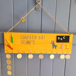 Wooden timetable for children. Can be personalized with the child&#39;s name. Useful, fun, and decorative back-to-school item.