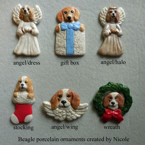 May include: A collection of Beagle porcelain ornaments. The ornaments include a dog angel, a dog holding a gift box, a dog angel with a halo, a dog in a stocking, a dog with wings, and a dog in a wreath. Text on the image reads "Beagle porcelain ornaments created by Nicole."