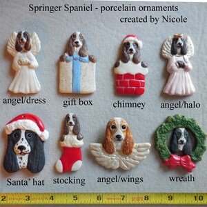 May include: A collection of Springer Spaniel porcelain ornaments. The ornaments include a dog in a Santa hat, angel wings, and a wreath. Other designs include a dog in a chimney, gift box, and stocking. The ornaments are approximately 2 to 4 inches in length.