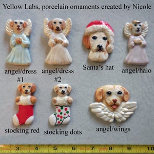 May include: A collection of porcelain ornaments featuring yellow Labrador retrievers. The ornaments include angel dogs, a dog wearing a Santa hat, and dogs in stockings. The text "Yellow Labs, porcelain ornaments created by Nicole" is visible.