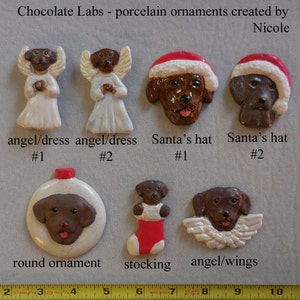 May include: A collection of porcelain ornaments featuring chocolate Labrador retrievers. The ornaments include angel figures, Santa hats, a round ornament, a stocking, and angel wings. Text on the image reads "Chocolate Labs - porcelain ornaments created by Nicole."
