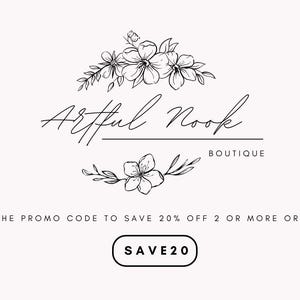 May include: Black and white logo for a boutique called "Artful Nook Boutique". The logo features a floral design with the text "Artful Nook" in a handwritten font. The text "Boutique" is below the floral design in a smaller font. The text "USE THE PROMO CODE TO SAVE 20% OFF 2 OR MORE ORDERS" is below the logo. A button with the text "SAVE20" is below the text.