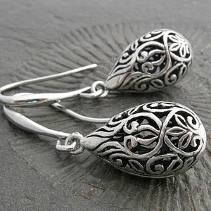 Filigree hollow silver plated drops on beautifully curved and oblong earwires. Feminine and delicate earrings. image 2