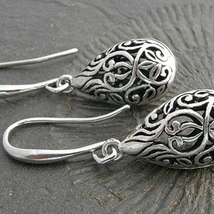 Filigree hollow silver plated drops on beautifully curved and oblong earwires. Feminine and delicate earrings. image 1