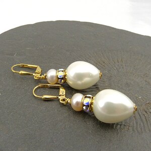 White pearl drops and Swarovski rondelles, gold-plated elements. Festive earrings, bridal jewelry, shell core, crystals, nickel free