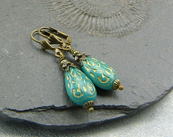 Retro inspired earrings with turquoise-green drops and golden filigree pattern. Nickel-free brass earwires. Vintage style