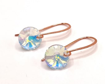 Small sparkling Rivoli earrings. Dainty jewelry on copper-colored ear hooks. Glass jewelry, festive earrings, minimalistic simple