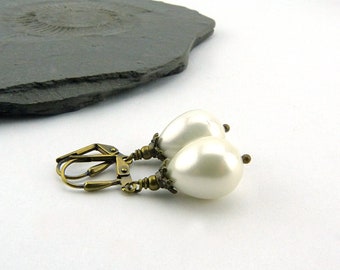 Timeless pearl drops Romantic vintage style earrings. Shimmering white shell core pearls with brass elements. Nickel-free jewellery