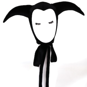 May include: A white ceramic mug with a black handle and the text "But First, Coffee" in a handwritten style. The mug is on a white surface. The mug is approximately 4 inches tall.