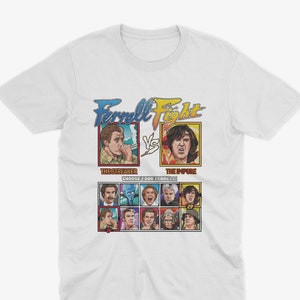 May include: White t-shirt with a graphic of a video game style fight scene featuring Will Ferrell as two different characters, "The Streaker" and "The Impure". The graphic includes the text "Ferrell Fight" and "Choose Your Ferrell!"