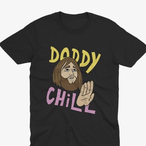 May include: Black t-shirt with a cartoon illustration of a man with a beard and the text "Daddy Chill" in yellow and pink.