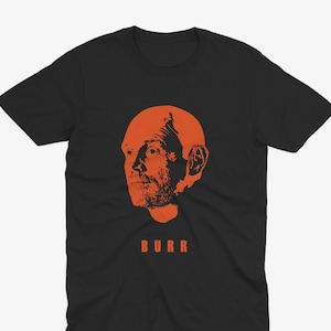 May include: Black t-shirt with an orange silhouette of a man's head and the word "BURR" printed below.
