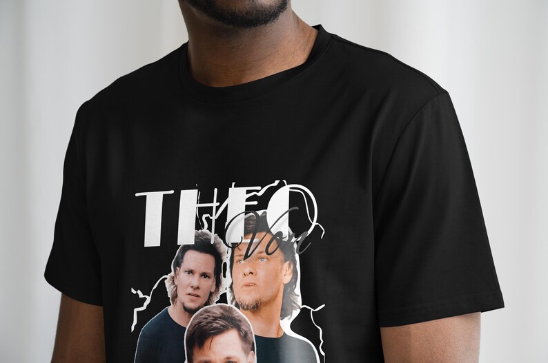 May include: Black t-shirt with a white graphic print of three men's faces and the text "THEO" in a stylized font.