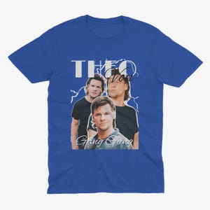 May include: A royal blue t-shirt with a white graphic of three men. The graphic features the text "Theo Von Gang Gang" and a lightning bolt design.